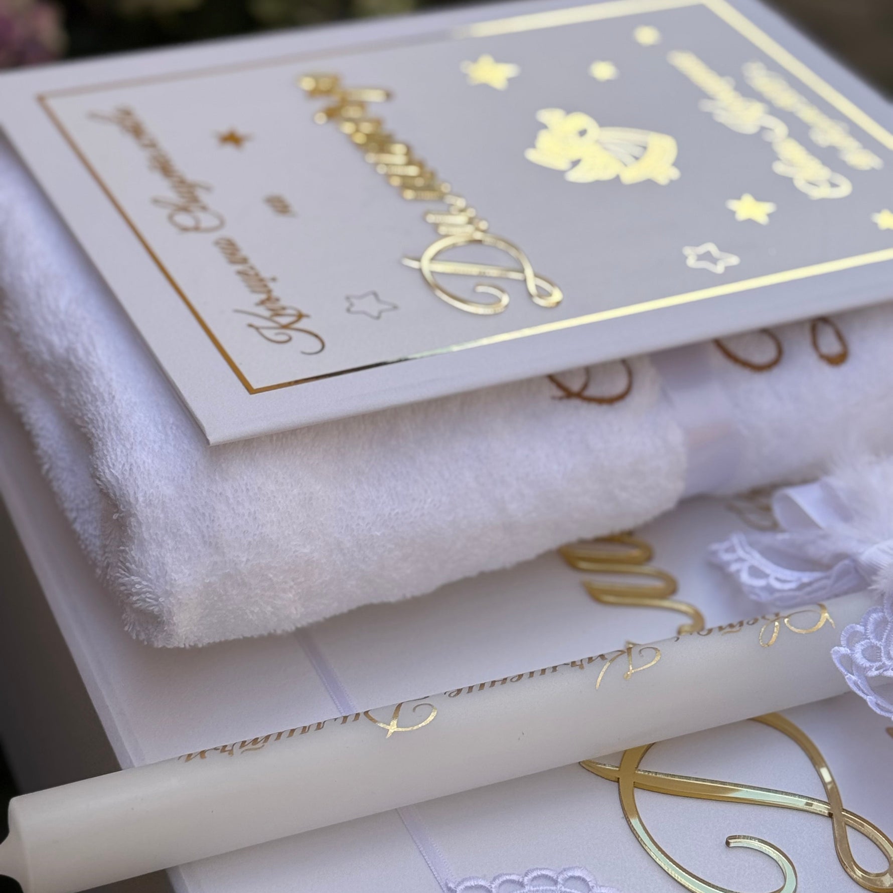 White towel with gold embroidery, Christening Candle with gold name engraved, and cerfificate folder