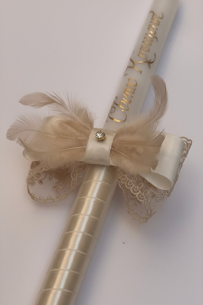 Champagne satin bow with gold lace and feathers decoration on a baptism candle