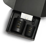 Two black candles in a gift box with a 'Thank You' card and scissors.