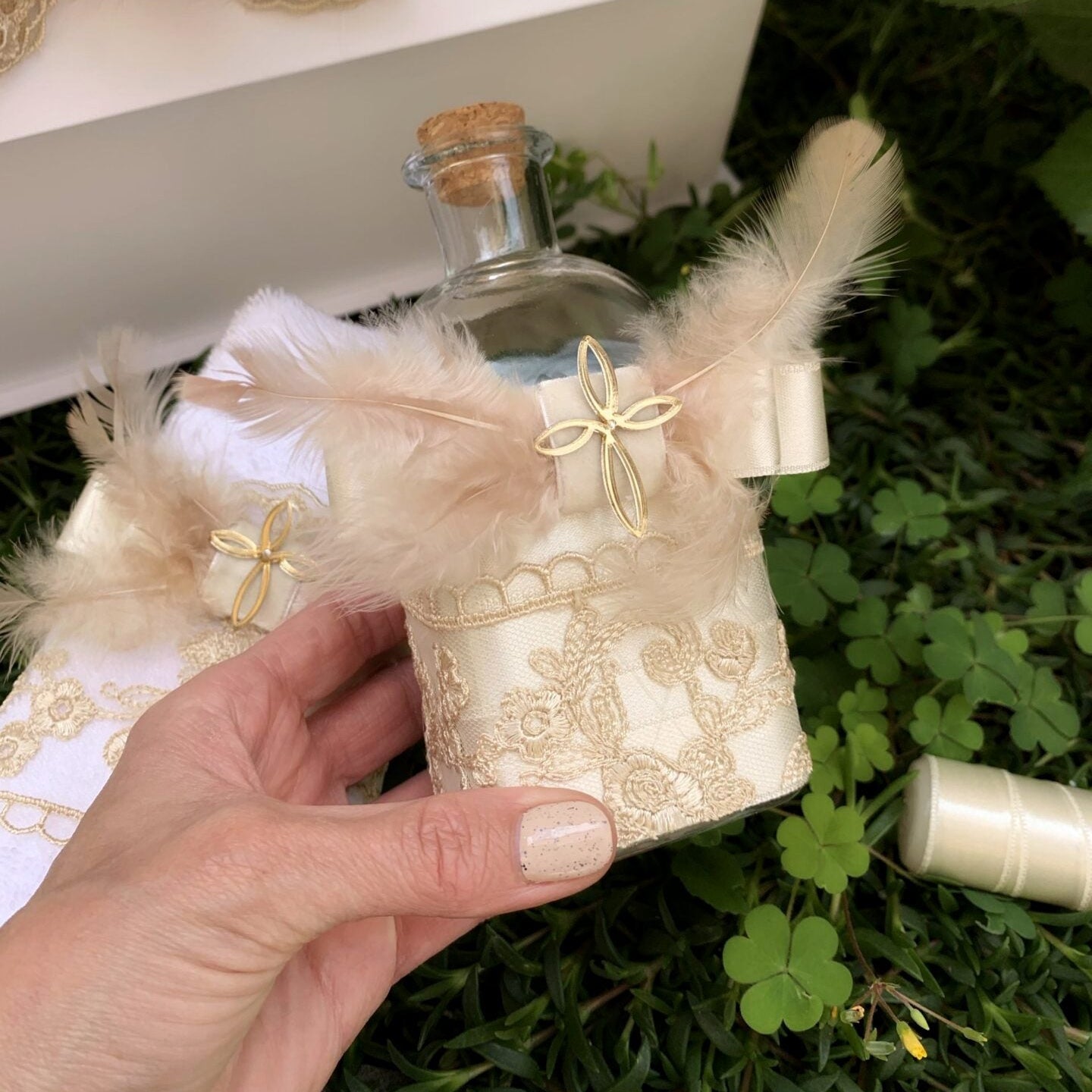 Decorative bottle with lace wrap and feather 