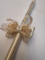 Personalized metallic gold text on a luxury champagne christening candle