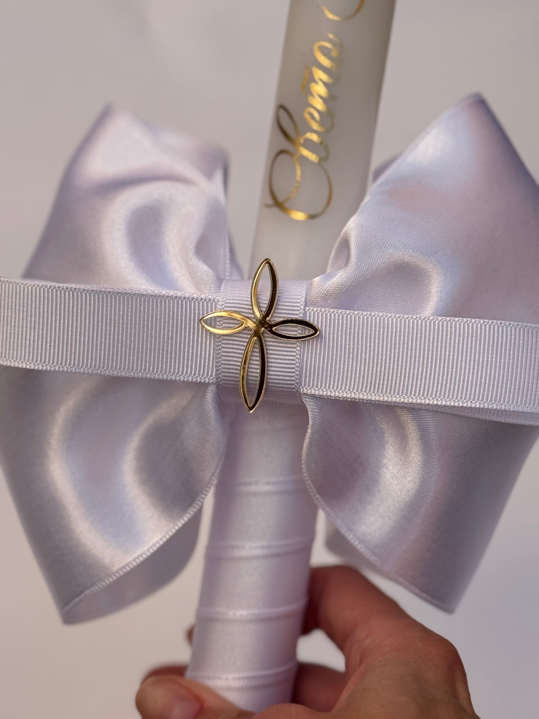 Traditional white and gold personalized baptism candle with gold inscription
